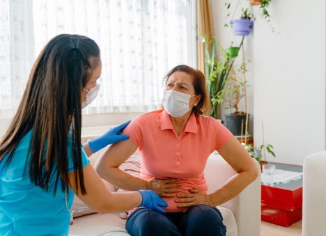 woman-having-medical-exam-with-doctor-on-illness-from-stomach-gallstones-concept